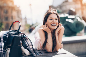 Young woman resting and laughing outdoors in the city Monroe Clear Aligners